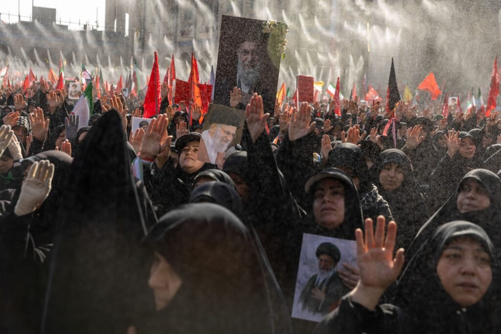 Mourners hold portraits of Supreme Leader Ayatollah Ali Khamenei on the second day of his funeral ceremonies at the Grand…